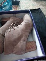 Boots inside original box showing stacked heel and suede exterior