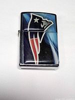 Front view of lighter showing Patriots logo and chrome edges