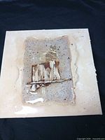 front view of small abstract mixed-media painting showing resin surface and collage