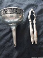 Funnel cup and nutcracker laid side by side showing overall form