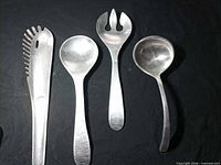 Front view of all four aluminum utensils