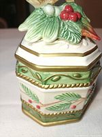 Side view showing holly design, green border, gold trim