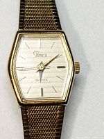 front view of Timex gold-tone watch showing dial and case