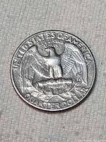 Reverse with eagle design, QUARTER DOLLAR legend, showing strike misalignment and surface pitting