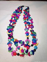 Full view of double strand multicolor crescent bead necklace