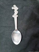 Full view of teaspoon showing Mickey Mouse handle and bowl