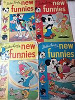 Four Walter Lantz New Funnies comic book covers displayed