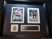 Full view of framed display showing cards, pin and plaque