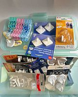 Overall lot view showing storage case with packaged hooks and clothespins