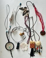 Group shot of all necklaces laid out on white background