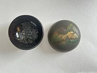 Lacquer box open showing gold-fleck interior and painted lid