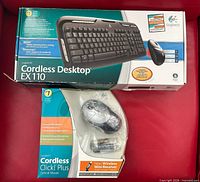 Retail box showing Cordless Desktop EX110 keyboard and mouse, and Cordless Click! Plus mouse packaging