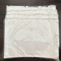 Stacked packaged tablecloth sets showing quantity