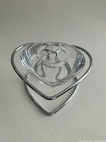 Glass candle holder nested in metal heart stand