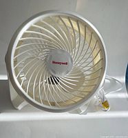 Front view of white Honeywell fan showing spiral grill and logo