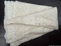 Tablecloth folded showing overall color and scalloped edge