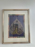 Front view of framed painted leaf artwork