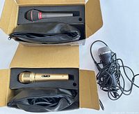 Two boxed microphones and one loose Rock Band mic with cable