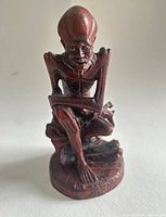 Full front view of carved wooden Malu figure on white background