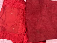 Close view of satiny and faux-suede placemats showing textures and stains