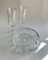 Two stemmed glasses and crystal dish grouped