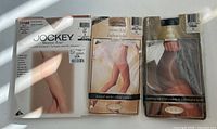 Front view of all three unopened pantyhose packages