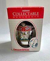 retail box front showing brand and carousel ornament inside