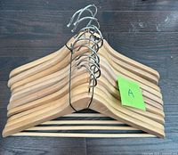 Stack of ten wooden hangers front view