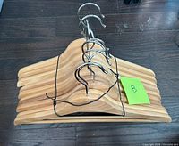 Stacked wooden hangers front view showing hooks and wood grain