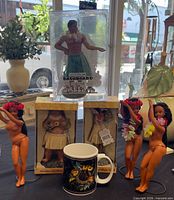 Group shot of all six dolls (boxed and loose) with mug