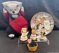 Group shot of all items: doll, plate, three figurines, basket