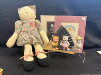Group shot showing cat doll, mats, fan, and three figurines