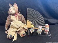 Group shot showing cloth cat doll, three small cat figurines, folding fan
