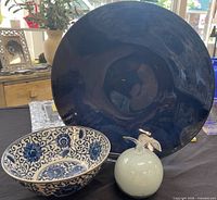 Overall view showing navy blue bowl, patterned bowl, glass apple
