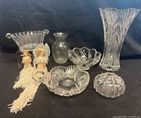Group view of all glass pieces and two dolls