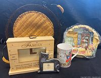 Group shot of basket, frames, mug, wall plaque