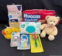 Group shot of all items including diapers, wipes, clothing, toys and accessories