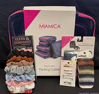 Group shot showing packing cubes, shoe bag, Wahl trimmer, scrunchies, Scunci bobby pins and Scunci hair comb clips