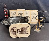 overview of lot including bowl, bottle, coasters, candle holders, prints