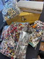 Bags of beads and two jewelry boxes closed