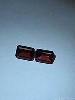 Front view of both garnets showing color and cut