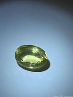 Top view of oval lemon citrine showing facets and color