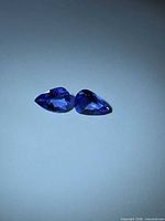 Pair of pear-cut violet-blue Tanzanite gemstones face up