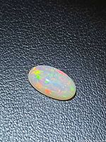 Top view of oval cabochon Ethiopian opal showing play-of-color