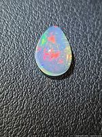 Front view of pear fire opal showing red and green flashes
