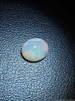 Front view of oval opal showing play of color