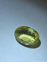 Oblique view of the faceted lemon citrine showing oval shape and color
