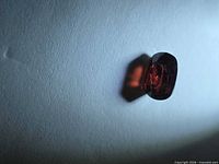 Front view of oval red spinel showing color and faceting