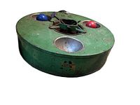 Side view of green cast iron Belmont Treeliter tree stand showing two recessed light wells with bulbs and Belmont logo