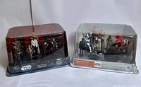 Front view of both sealed Star Wars Deluxe Figurine Sets